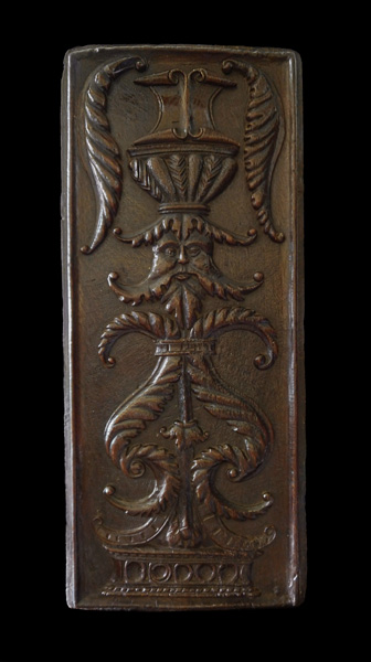 Tall panel with face and urns